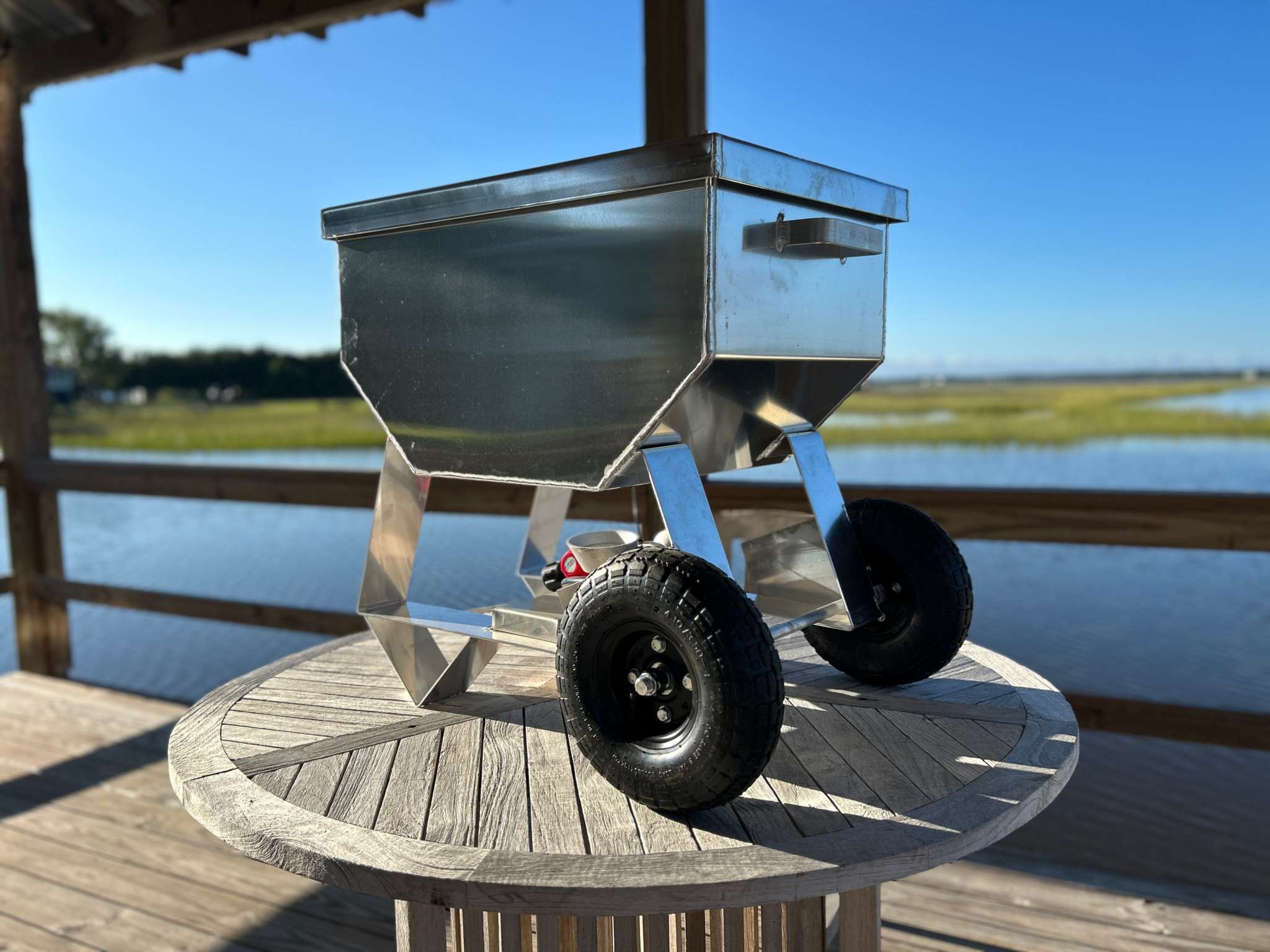 Wheeled Classic Cooker with pneumatic tires on a wooden deck by the shoreline.