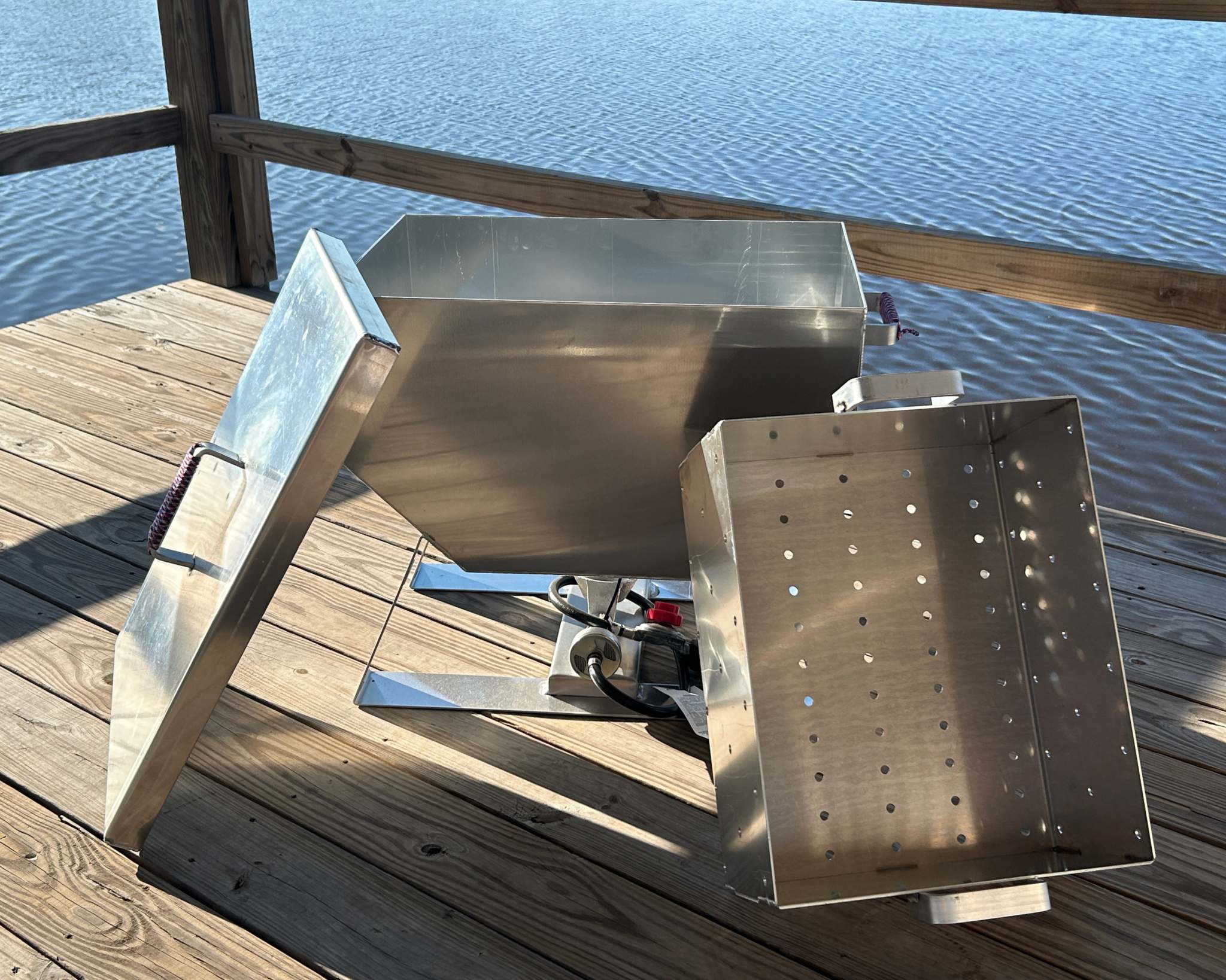 35-quart aluminum oyster steamer cooker on a wooden deck by the water.