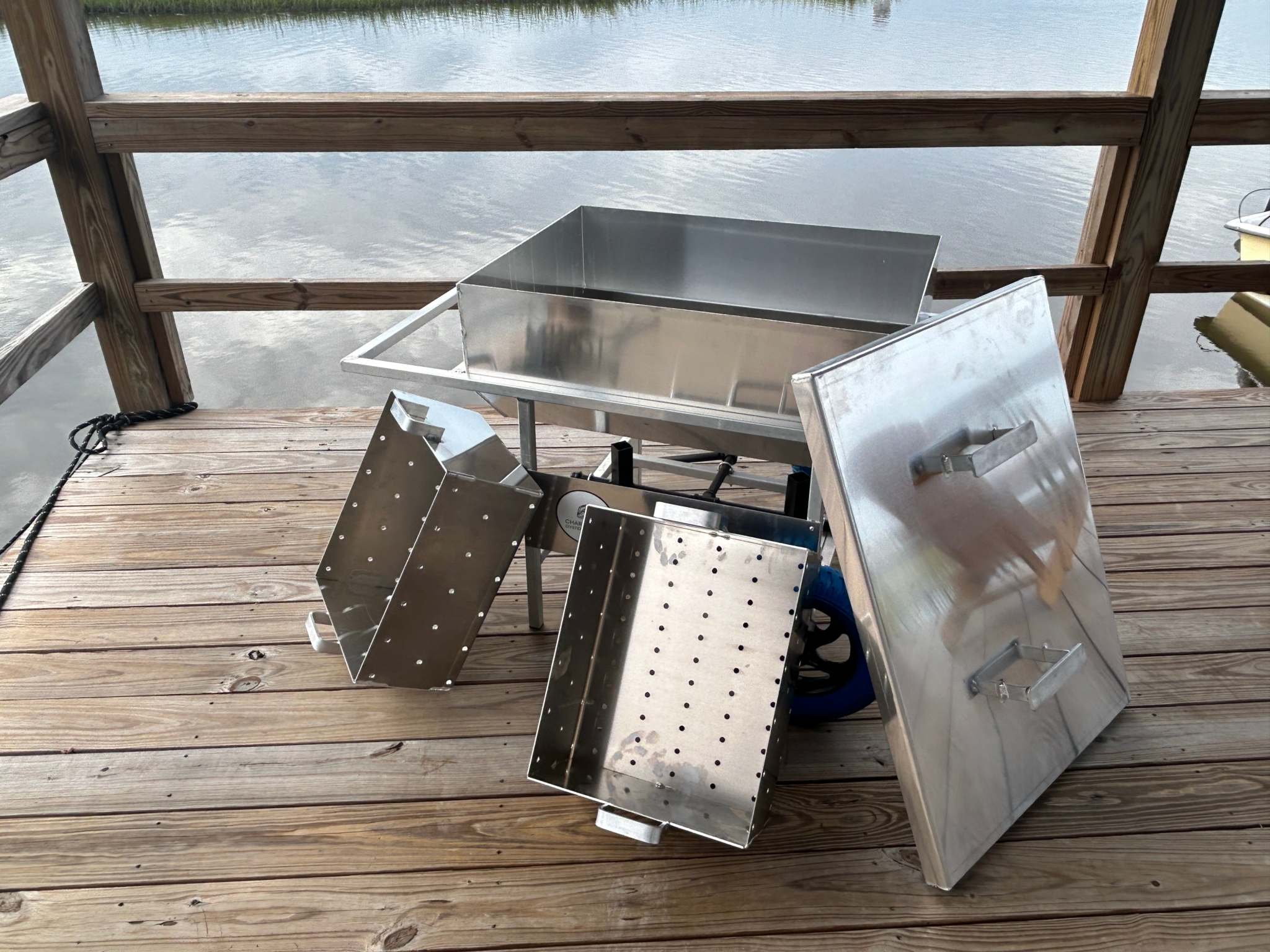 Double Classic Rental cooker setup on wooden deck by water.