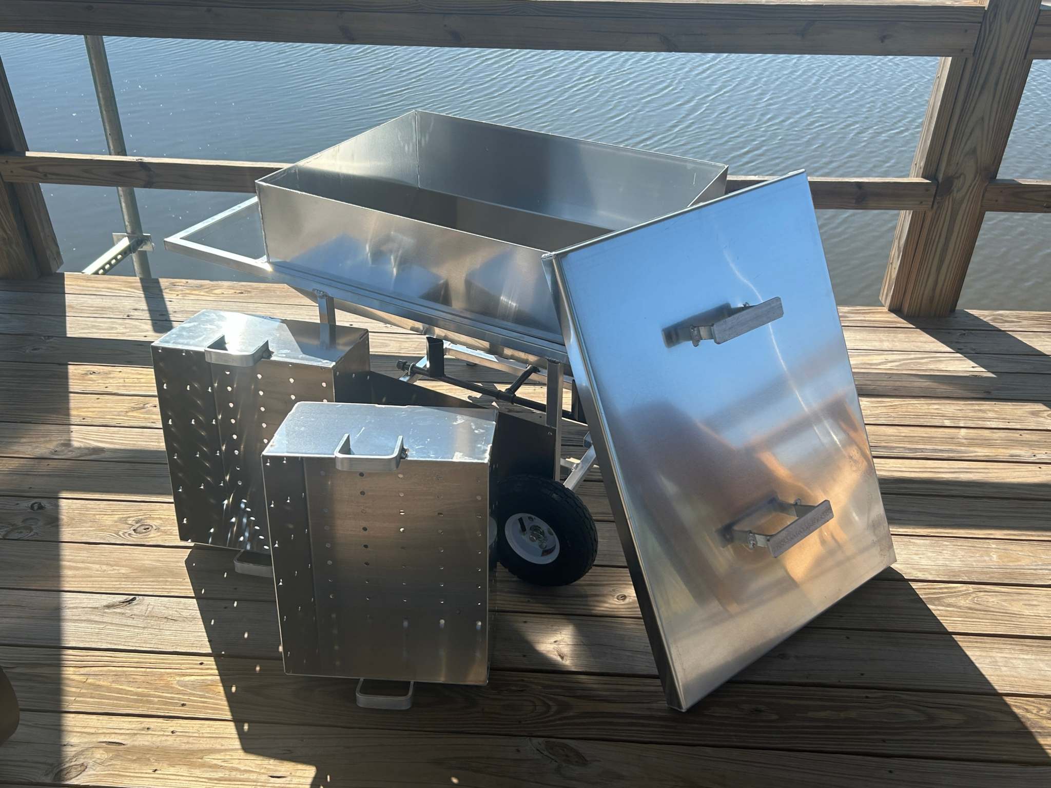 Double Basket Classic wheeled cooker on wooden deck with premium aluminum construction for seafood steaming and boiling.