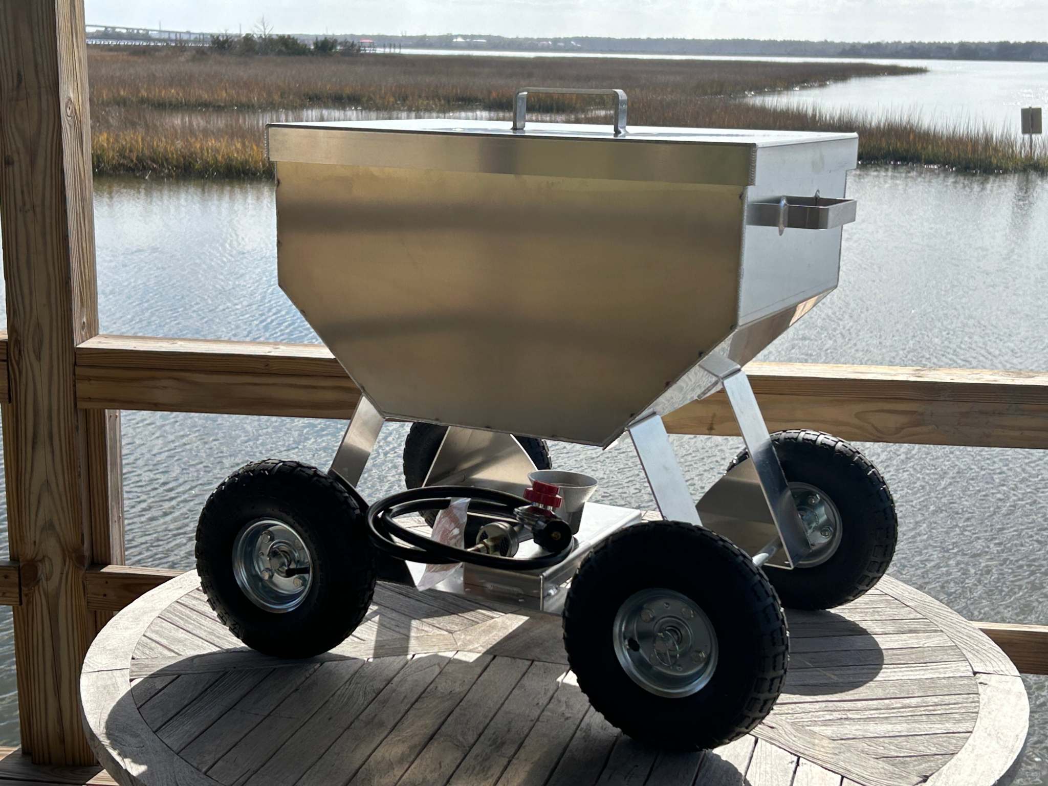The Classic 4x4 seafood cooker made of marine-grade aluminum on a wooden deck.