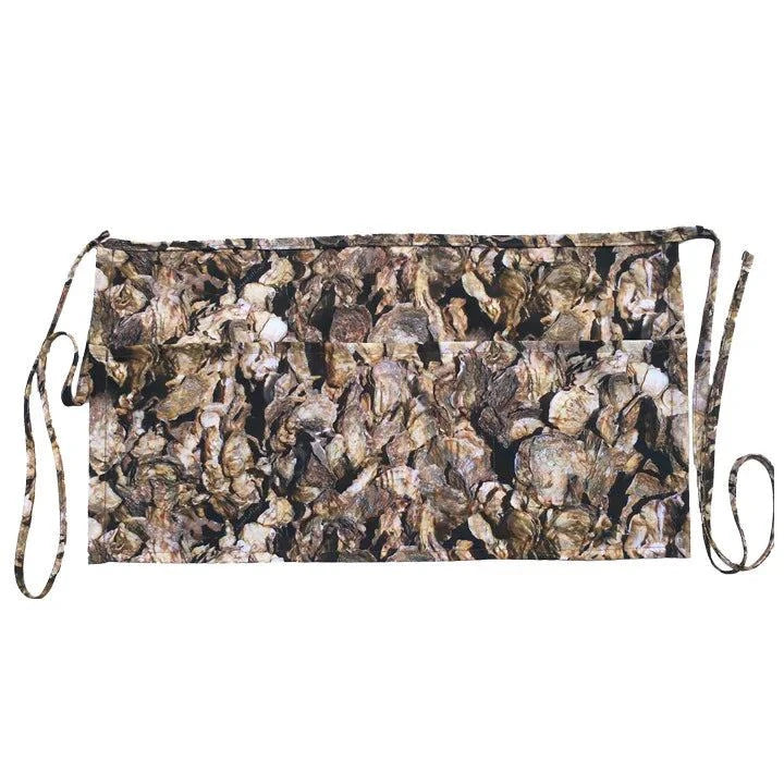 The Charleston Oyster Apron with oyster shell pattern, featuring multiple pockets and durable cotton straps.